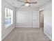 Carpeted bedroom with neutral walls, a bright window, and a ceiling fan at 3357 Ellingford Rd, Charlotte, NC 28214