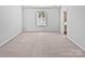 Bright bedroom featuring a neutral carpet and a large window allowing ample natural light at 3357 Ellingford Rd, Charlotte, NC 28214