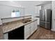 Modern kitchen with stainless steel appliances, granite countertops, and white cabinetry at 3357 Ellingford Rd, Charlotte, NC 28214