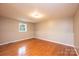 Spacious bedroom with hardwood floors and a window overlooking the yard at 390 15Th Ne Ave, Hickory, NC 28601