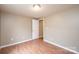 Clean bedroom with laminate floors, light walls, and bright overhead lighting at 390 15Th Ne Ave, Hickory, NC 28601