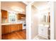 Bright kitchen with hardwood floors, ample cabinet space, white appliances, and a view into the bathroom at 390 15Th Ne Ave, Hickory, NC 28601