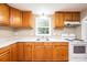 Well-lit kitchen with wood cabinets, white countertops and appliances, and a window overlooking the outdoors at 390 15Th Ne Ave, Hickory, NC 28601