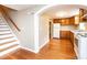 Kitchen featuring wooden cabinets, white appliances, and hardwood floors at 390 15Th Ne Ave, Hickory, NC 28601