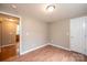 Clean room with laminate floors, light walls, and bright overhead lighting at 390 15Th Ne Ave, Hickory, NC 28601