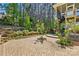 Stone patio with a fire pit surrounded by lush landscaping at 404 Brookridge Dr, Mount Holly, NC 28120