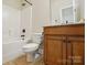 Bathroom showcasing a toilet, vanity, and a shower-tub combination at 404 Brookridge Dr, Mount Holly, NC 28120