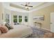 Calm bedroom features large windows, tray ceilings, and neutral decor at 404 Brookridge Dr, Mount Holly, NC 28120