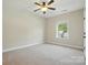 Clean bedroom featuring neutral carpet, a ceiling fan, and a window providing natural light at 404 Brookridge Dr, Mount Holly, NC 28120