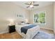 Bright bedroom with ceiling fan, large window, and neutral carpet and walls at 404 Brookridge Dr, Mount Holly, NC 28120