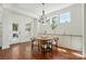 Bright dining area with wood table, chandelier, and natural light at 404 Brookridge Dr, Mount Holly, NC 28120