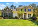 Charming two-story home with a stone facade, landscaped yard, shutters, and inviting front porch at 404 Brookridge Dr, Mount Holly, NC 28120