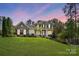 Charming two-story home with a well-manicured lawn and a stone facade at 404 Brookridge Dr, Mount Holly, NC 28120