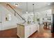 Bright kitchen features a granite island, hardwood floors, and an open floor plan at 404 Brookridge Dr, Mount Holly, NC 28120