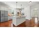 Gourmet kitchen with granite countertops, stainless steel appliances, and large center island at 404 Brookridge Dr, Mount Holly, NC 28120