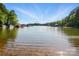 Gorgeous view of a scenic lake surrounded by lush trees and docks at 404 Brookridge Dr, Mount Holly, NC 28120