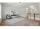 Spacious living room with a gray rug, two chairs, table, and bright natural light at 404 Brookridge Dr, Mount Holly, NC 28120