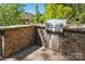 Outdoor kitchen with stainless steel grill set in a stone surround at 404 Brookridge Dr, Mount Holly, NC 28120