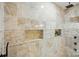 Detailed close-up of shower niche and travertine tiling in the large walk-in shower at 404 Brookridge Dr, Mount Holly, NC 28120