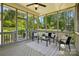 Relaxing screened-in porch with a ceiling fan and views of the lush backyard at 404 Brookridge Dr, Mount Holly, NC 28120