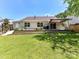 Well-manicured backyard with a patio, lush lawn, mature trees, and outdoor seating at 4143 Tullock Creek Dr, Charlotte, NC 28269