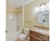 Bathroom features granite countertop, single sink vanity, and tub shower at 4143 Tullock Creek Dr, Charlotte, NC 28269