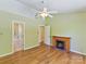 Large bedroom with a decorative fireplace, hardwood floors and a ceiling fan at 4143 Tullock Creek Dr, Charlotte, NC 28269