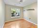 Bright bedroom with hardwood floors, a window view, and a modern track lighting at 4143 Tullock Creek Dr, Charlotte, NC 28269
