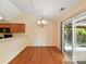 Bright dining area with sliding glass door and chandelier at 4143 Tullock Creek Dr, Charlotte, NC 28269