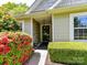 Welcoming entrance with a decorative stone accent wall and vibrant red bushes at 4143 Tullock Creek Dr, Charlotte, NC 28269