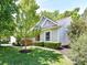 Charming home with a well-manicured lawn, mature trees, and colorful landscaping at 4143 Tullock Creek Dr, Charlotte, NC 28269