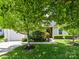 Beautifully landscaped front yard with lush greenery and a charming exterior at 4143 Tullock Creek Dr, Charlotte, NC 28269
