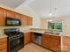 Kitchen boasts stainless appliances, wood cabinets and bright recessed lighting at 4143 Tullock Creek Dr, Charlotte, NC 28269