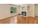 Cozy living room with hardwood floors and a fireplace, filled with natural light at 4143 Tullock Creek Dr, Charlotte, NC 28269