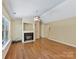 Spacious living room with a fireplace and a ceiling fan, bathed in natural light at 4143 Tullock Creek Dr, Charlotte, NC 28269