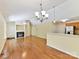 Open-concept living area featuring hardwood floors and a cozy fireplace at 4143 Tullock Creek Dr, Charlotte, NC 28269