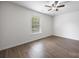 Inviting bedroom with hardwood floors, a ceiling fan, and a window overlooking the lush, green outdoors at 4219 Shasta Cir, Clover, SC 29710