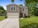 Charming two-story home featuring a two-car garage, landscaped yard, and classic architectural details at 4219 Shasta Cir, Clover, SC 29710