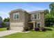 Attractive two-story home with a well-maintained lawn, a two-car garage, and charming landscaping at 4219 Shasta Cir, Clover, SC 29710