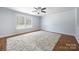 Cozy living room with hardwood flooring, natural light from a large window, and a plush area rug at 4219 Shasta Cir, Clover, SC 29710