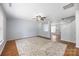 Bright open floor plan with hardwood floors, ceiling fan, and view to the kitchen at 4219 Shasta Cir, Clover, SC 29710