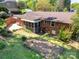 Aerial view of a backyard, showing a screened-in porch, brick patio, and planting area at 4925 Seacroft Rd, Charlotte, NC 28210