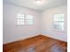 Bright bedroom with hardwood floors features two windows offering ample natural light at 4925 Seacroft Rd, Charlotte, NC 28210