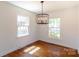 Light-filled dining room featuring hardwood floors, bright white walls, and modern lighting at 4925 Seacroft Rd, Charlotte, NC 28210