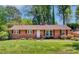 Charming brick home with red shutters and a well-manicured lawn and landscaping at 4925 Seacroft Rd, Charlotte, NC 28210
