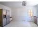 Spacious kitchen area with stainless steel refrigerator and rear door at 4925 Seacroft Rd, Charlotte, NC 28210