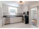 Bright kitchen features stainless steel appliances and white cabinets at 4925 Seacroft Rd, Charlotte, NC 28210
