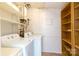 Functional laundry room with washer, dryer, shelves, and wooden storage provides ample space at 4925 Seacroft Rd, Charlotte, NC 28210