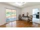 Living room features wood floors, a sliding glass door to the porch, and stylish furniture at 4925 Seacroft Rd, Charlotte, NC 28210