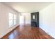 Bright living room with hardwood floors, a brick fireplace, and lots of natural light at 4925 Seacroft Rd, Charlotte, NC 28210